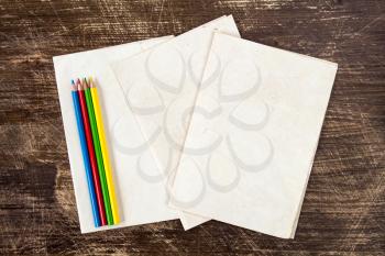Four color pencils with copy-space on paper background