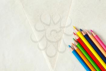 Colorful pencils with copy-space on paper background,education frame concept.
