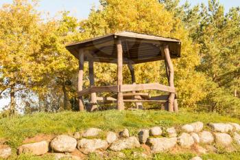 Wooden arbour among the trees in on the hill
