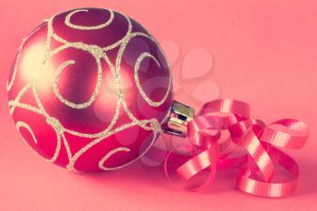 Christmas ball with ribbon on paper background