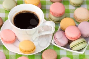 Delicious french macaroons with cup of black coffee
