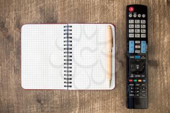 Tv remote control and blank notebook for copy-space