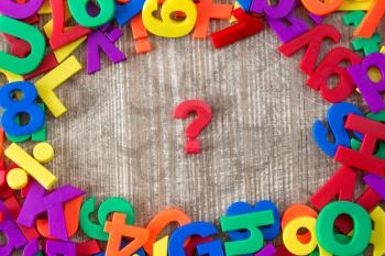 Border of colorful letters and numbers with question mark in a middle 