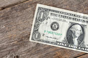 One dollar on the wooden background. United states money, finance concept