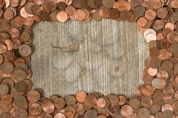 Frame from Euro cents with copy-space on wooden background