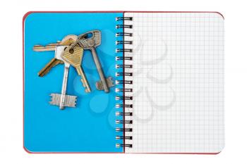 Blank notebook and bunch of keys, isolated on white background