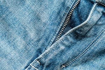 Close up view of the blue jeans zipper. Copy space.