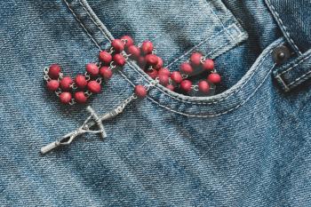 Catholic rosary in the pocket of the denim  jeans