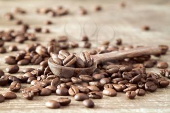 Wooden spoon with coffee crop beans