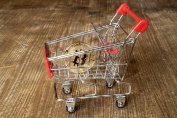 Concept Of Purchasing Cryptocurrency. Bitcoin In The Shopping Cart.