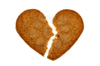 Broken gingerbread heart isolated on white background