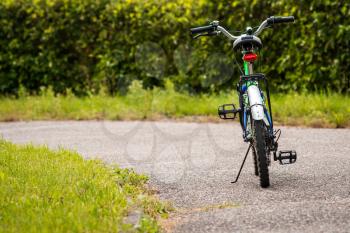 Child's bike rear view standing on the road