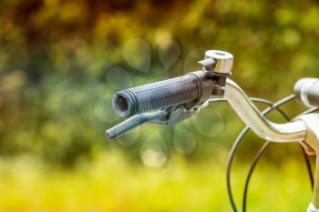 Detail of a used bicycle handlebar on blurry nature background