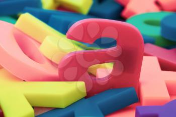 Pink letter a on the pile of colorful plastic letters 