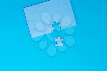 Blue details of puzzle on blue background. Problem solving concept.