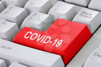 Computer keyboard with text Covid-19. Concept of studying Covid-19 by using modern computer technology.
