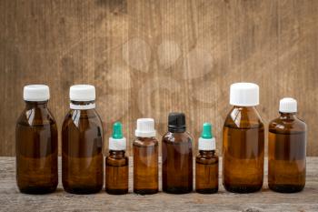 Row of  small bottles with medicinal solution on wooden background