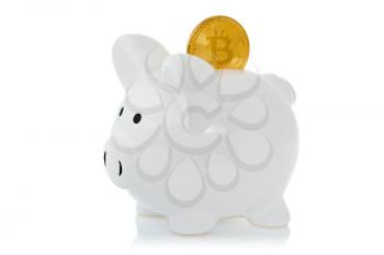 Piggy bank with Bitcoin coin isolated on white background. Saving Bitcoins, conceptual image for investment to virtual currency