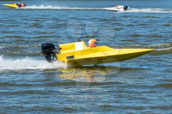 Yellow speed boat in fast action race
