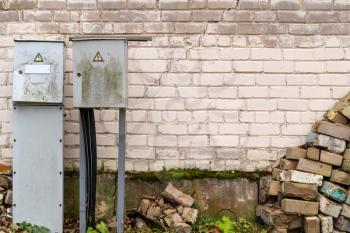 Power supply box on the brick wall of abandoned house