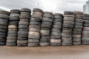 Pile of old car tires on the ground, ready for recycling