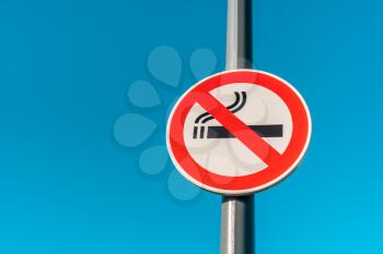 An outdoor Smoke-Free sign agains blue sky background