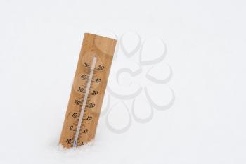Thermometer on snow showing low temperature in celsius 