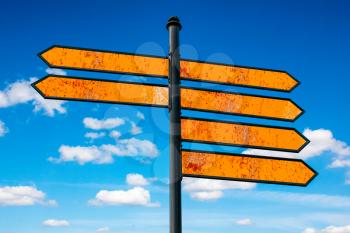 Rusty metal directional signs over cloudy sky background