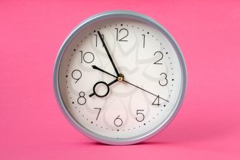Time concept with watch or clock on pink background