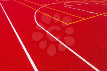 Newly made outdoor basketball court. Visible surface texture, freshly painted lines.