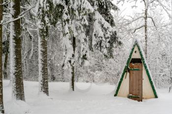 Toilet in the winter forest after heavy snowfall