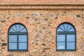 Modern plastic windows in the old brick building