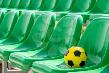 Line of stadium chairs with a soccer ball