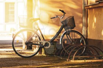 City bicycle with basket. Bicycle stand - Parking for bicycles in a city.