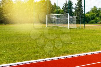 Empty gate on the football field with green grass. Concept of training in football sections and schools, preparation for competitions and matches.