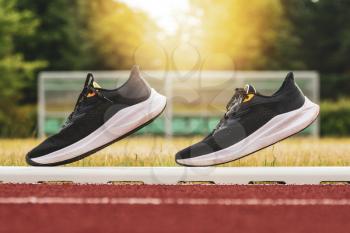 Pair of sports shoes standing on a running track. Healthy life concept.