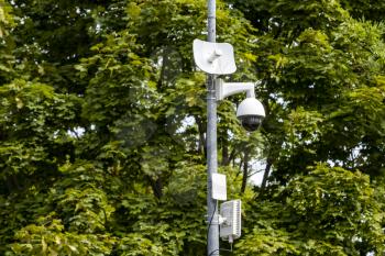 CCTV camera on metal pole in public park for monitor, observe and record evidence of incident for investigation and prevent criminal.