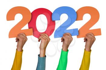 Hands with colorful numbers shows year 2022. New Years concept.