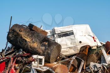 Mountain of metal ready for recycling. Scrapheap at a scrap metal business site, blue sky