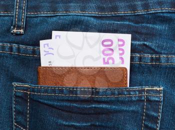 Pocket money in the elegant blue jeans and passport
