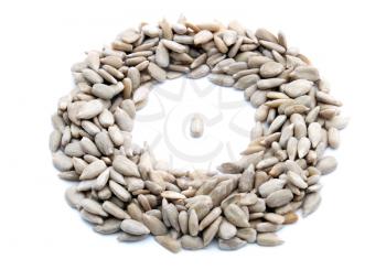 Cleaned sunflower seeds in the ring on white