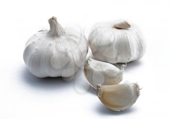 Two garlics with two pieces on white background