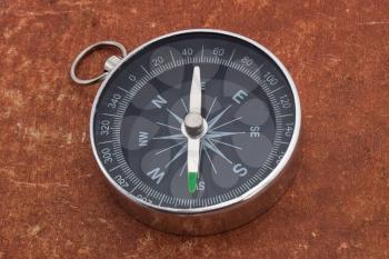 Old style compass on aged surface