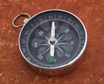 Old style compass on aged surface