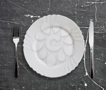 Plate and silverware on old table