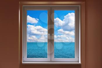 Windows with view to sea with cloudy sunny sky