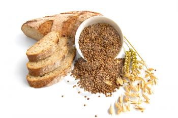 Bread, sliced, a cup of buckwheat, buckwheat on the table, the stalks of oats, wheat, isolated on a white background