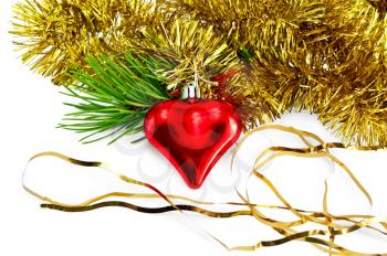 Christmas decorations in the form of a red heart, a branch of pine, gold tinsel isolated on white background