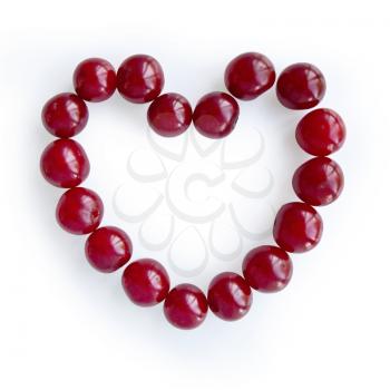 Cherry arranged in the form of hearts isolated on white background