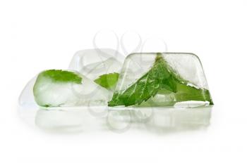 Ice with mint leaves isolated on white background
